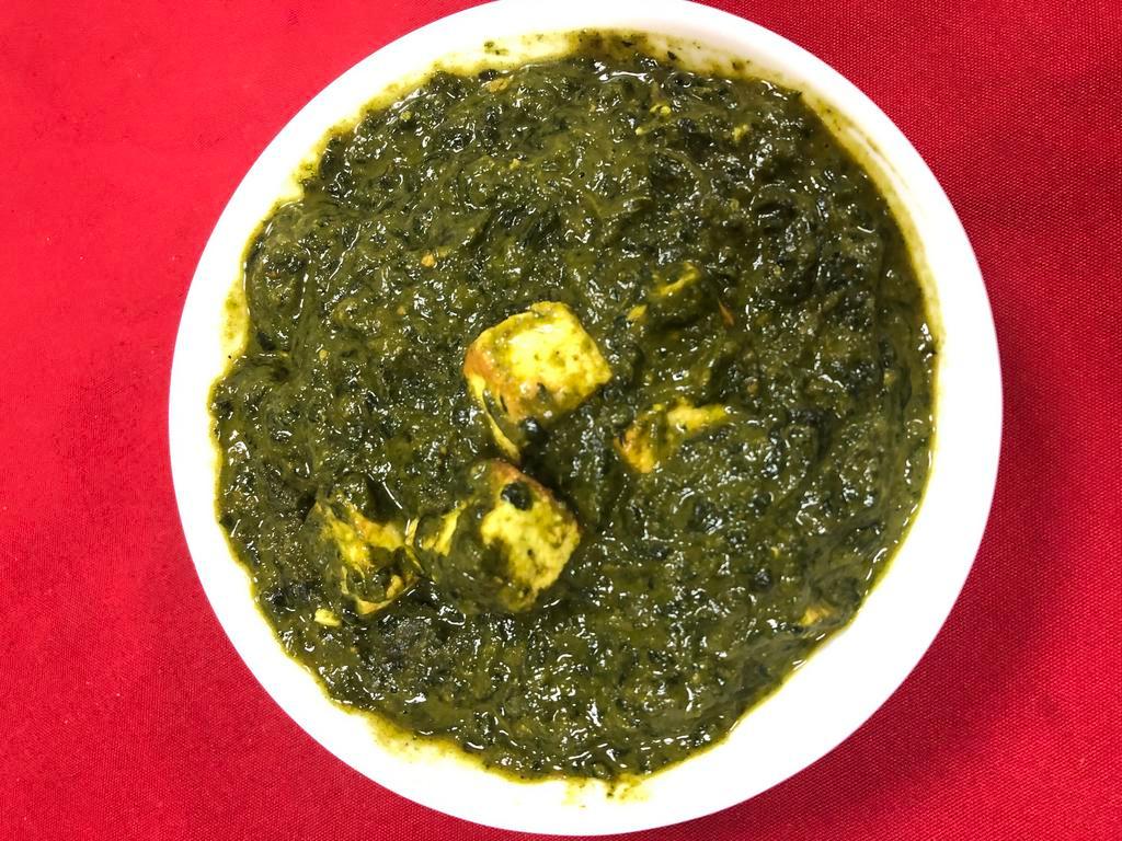 Saag Paneer  · Spinach cooked with cheese cubes, and seasoned with freshly grounded herbs.