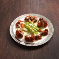 Buffalo Cauliflower Wings · Homemade hot and spicy buffalo sauce-covered cauliflower with a side of ranch dressing.