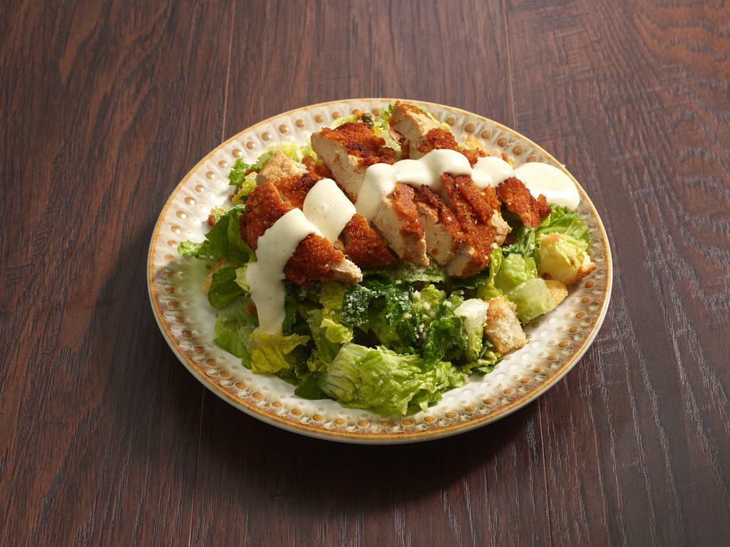 Chicken Caesar Salad · Crispy chicken, romaine hearts, capers with house made caesar dressing and croutons.