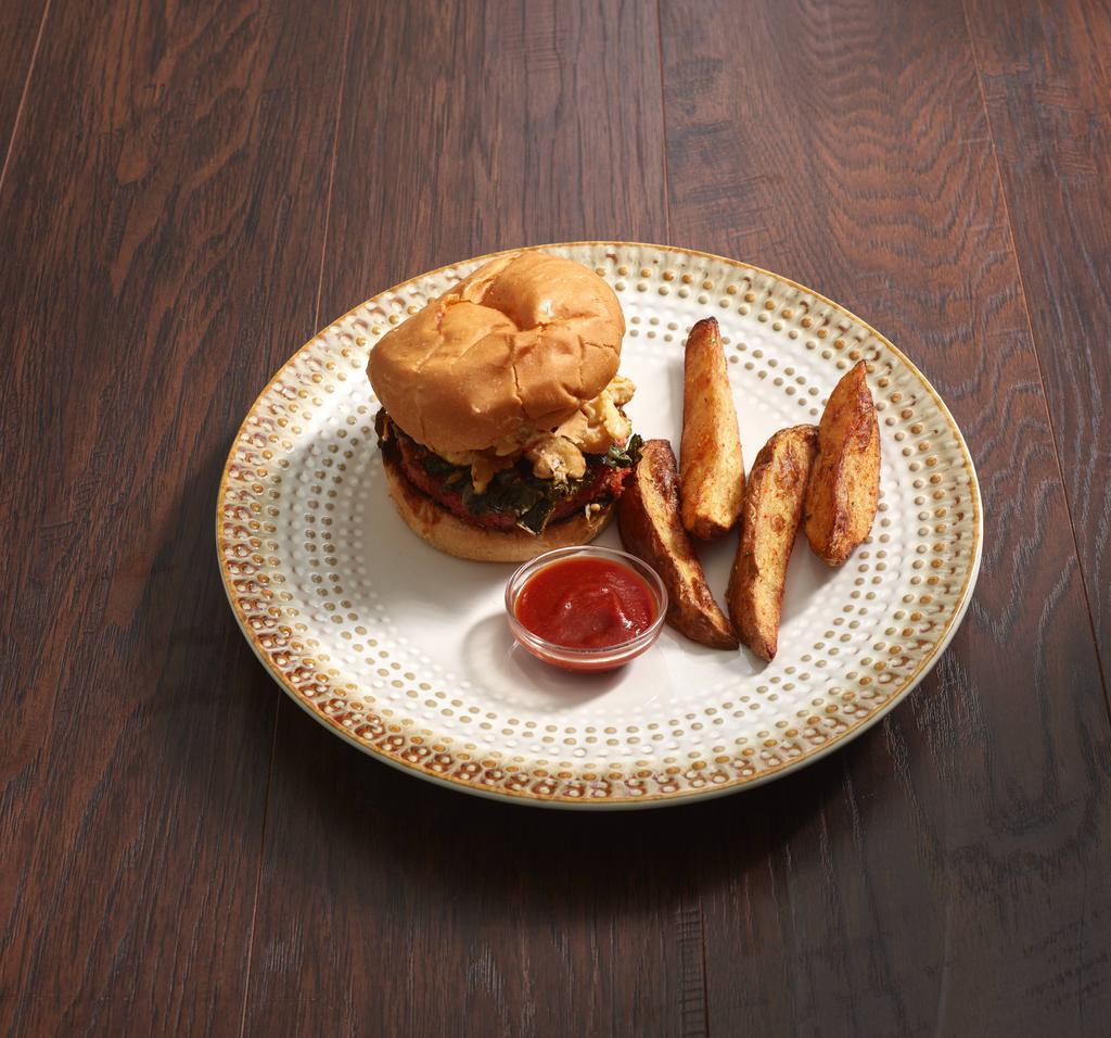 Mac Daddy Burger · A kickass burger topped with creamy mac n cheese, collard greens, gochujang BBQ sauce, and secret burger sauce. Served with fresh cut fries and organic ketchup.