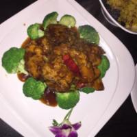 M16. Orange Seitan · Wheat protein sauteed in a spicy orange sauce, over a bed of broccoli. With brown rice and c...