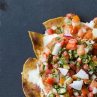 Nachos · Served with chips, cheese, sour cream, and pico de gallo.
