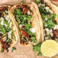 Bistec Taco · Flame-grilled steak with onion and cilantro.