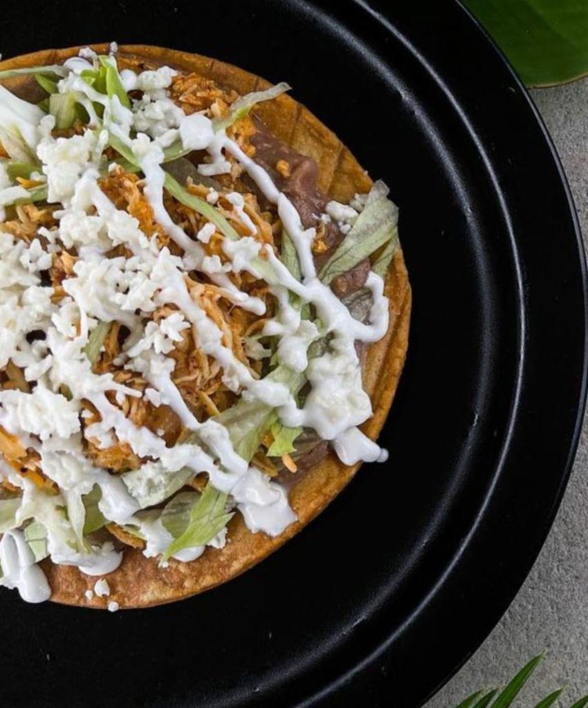 Tostadas · Toasted corn tortilla, beans, lettuce, cheese, sour cream, and choice of protein.