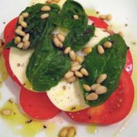 Mozzarella Caprese · Sliced mozzarella cheese with tomato. 