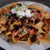Grande Nachos · Fresh tortilla chips topped with house refried beans, queso, black olives, tomatoes and gree...