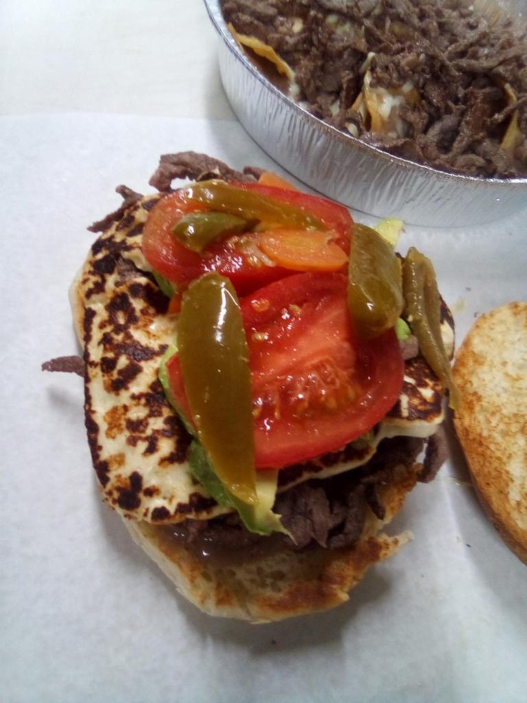 Carne Azada Torta · Grilled beef. Homemade soft roll, layered with refried beans, lettuce, tomato, raw onions, avocado, jalapeño and mayo.