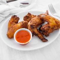 3 Chicken Wings · Cooked wing of a chicken coated in sauce or seasoning.