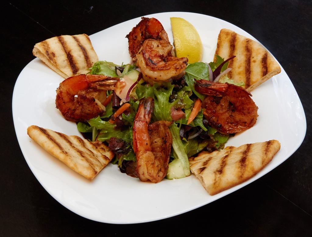 The Greek Goddess Salad · Grilled marinated shrimp, feta cheese, Kalamata olives, tomatoes, cucumbers, red onions, field greens, grilled pita bread and Mediterranean feta dressing.