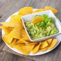 Chips with Guacamole · Thinly sliced crispy potato with a creamy dip made from avocado.