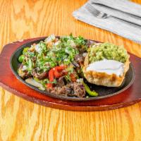Fajitas Platos · Grilled steak or chicken with sauteed peppers and onions, served with sour cream guacamole P...