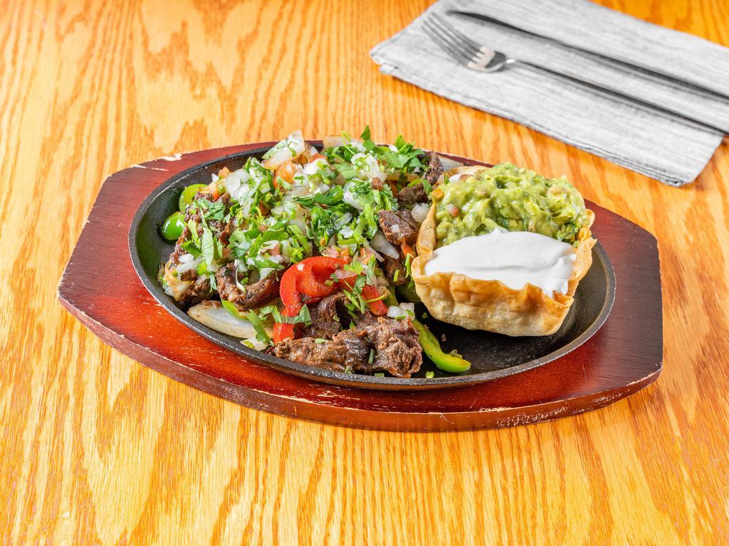 Fajitas Platos · Grilled steak or chicken with sauteed peppers and onions, served with sour cream guacamole Pico de Gallo and rice and beans.
