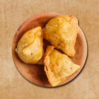 Downtown Samosa · Fried pastry filled with spiced potato and peas and  then deep fried till golden and crisp.

