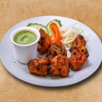 Chicken Triumph · Bonless pieces of chicken marinated with Indian spices and processed in Indian clay oven.