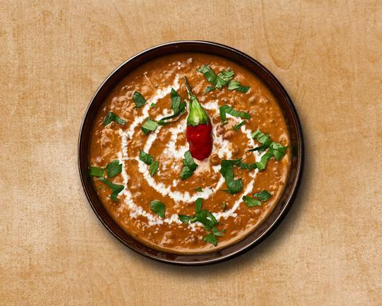 Creamy Black Lentils · Creamy black lentils cooked with tomato puree and Indian spices.