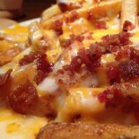 Loaded Cheese Fries · A mountain of sidewinder fries piled high, topped with cheddar cheese and bacon bits. Served...