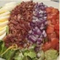 Chicken Cobb Salad · Grilled chicken, bacon bits, diced tomatoes, chopped onions and sliced eggs atop a bed of ro...