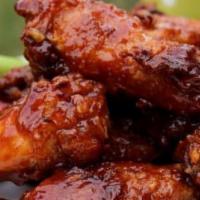 Honey BBQ Wings · Wings are tossed in pure honey before adding our classic BBQ sauce. Served with celery stick...