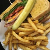 Club Sandwich · Sliced turkey and ham, lettuce, tomato, onions, bacon, mayo and American cheese on a toasted...