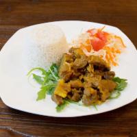 Curry Goat ·  Goat Meat infused with Curry Powder, Chopped Onions, Ginger, Thyme, Scallions
