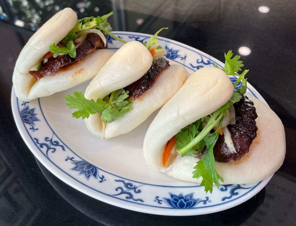 Roast Duck Buns  (3) · Three (3) folded steamed buns filled with tender slices of our signature roast duck, hoisin, scallion, and cilantro.