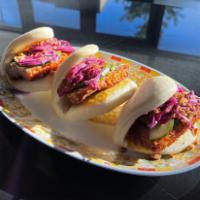 Pork Belly Buns · Slices of crispy pork belly on folded steamed buns (3), topped with pickles, cabbage, and gr...