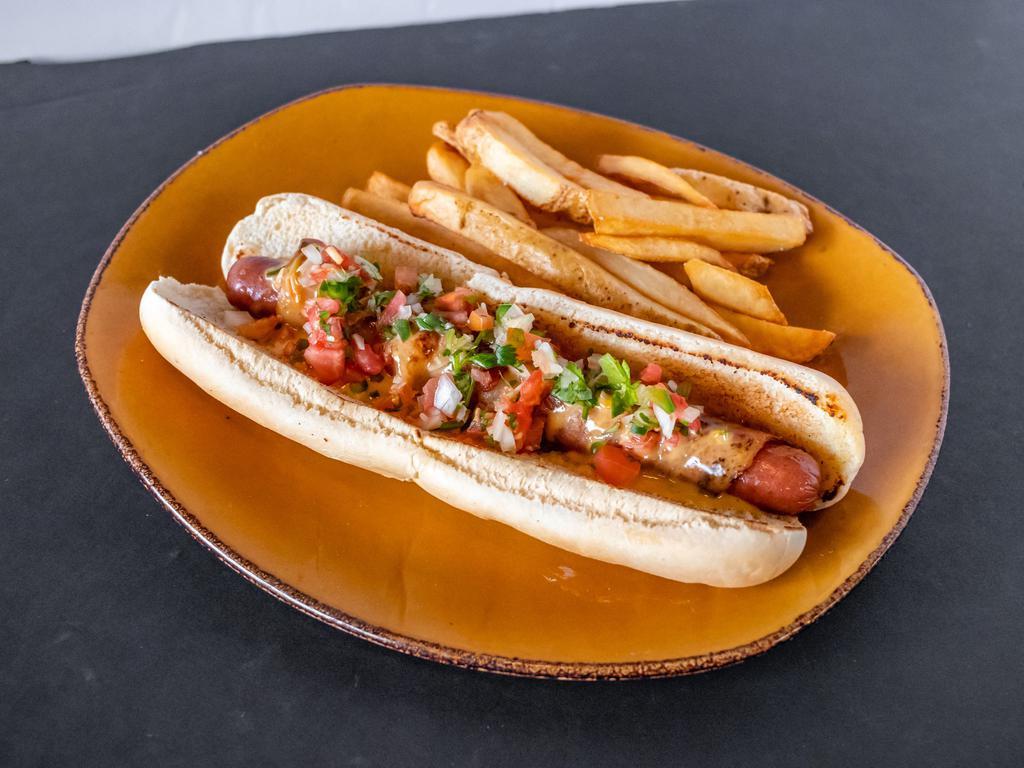 Perro Caliente · A signature Steelhouse plate! Foot long American dog wrapped with bacon and loaded with queso and pico de gallo.