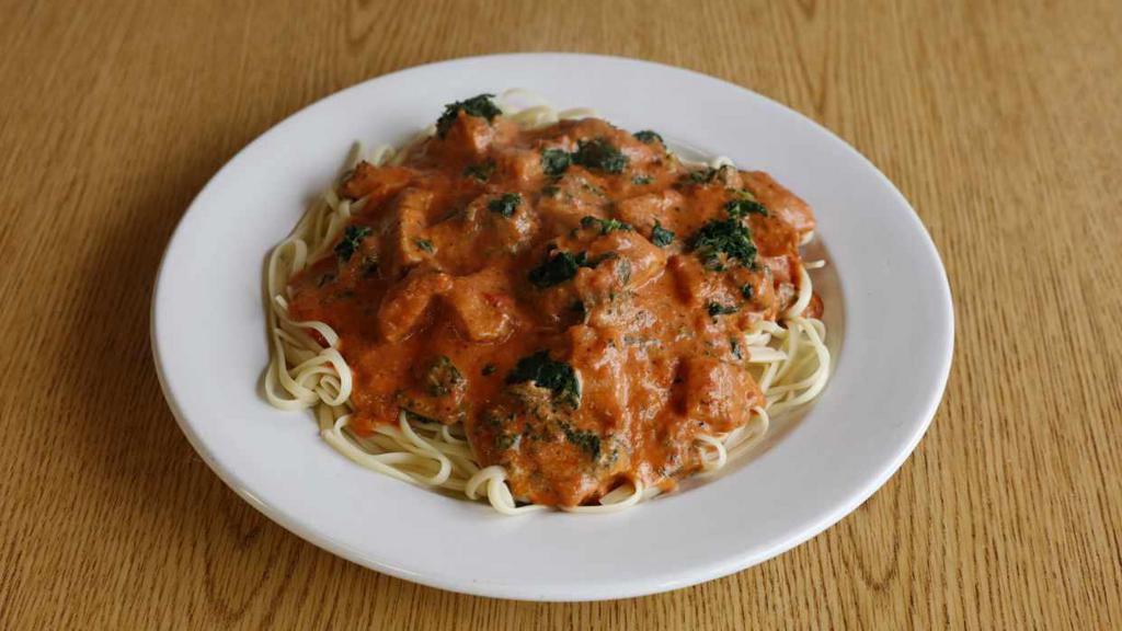 Pasta with Chicken Fiorentina · Chicken and spinach in creamy tomato sauce.