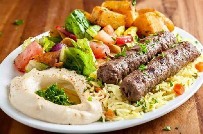 Kabab Plate · Saffron Rice, Romaine Lettuce, Tomato, Onion, Feta cheese, Homemade garlic sauce, Homemade hot sauce, Hummus, Tzatziki, and a Pita Bread