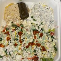 Greek Salad · A mix of lettuce, tomato, onion, carrot, purple cabbage, tabouli and feta cheese, tzatziki a...