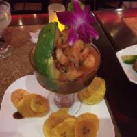 Mamajuana Ceviche Mixto · Fish and shirmp marinated in fresh citrus juice, mixed, with tomatoes
onions and roasted pep...