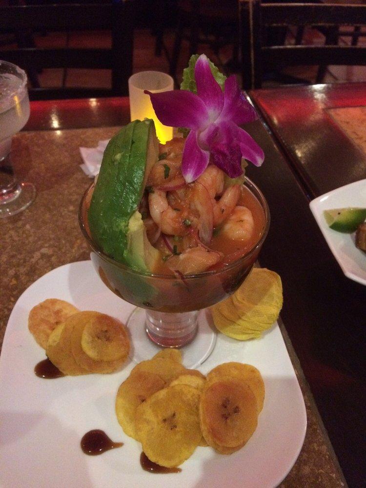 Mamajuana Ceviche Mixto · Fish and shirmp marinated in fresh citrus juice, mixed, with tomatoes
onions and roasted peppers and served with plantain chips.