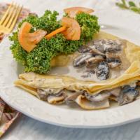 La Forestiere Crepe · Ham or roasted turkey breast, swiss cheese, mushroom, bechamel sauce
