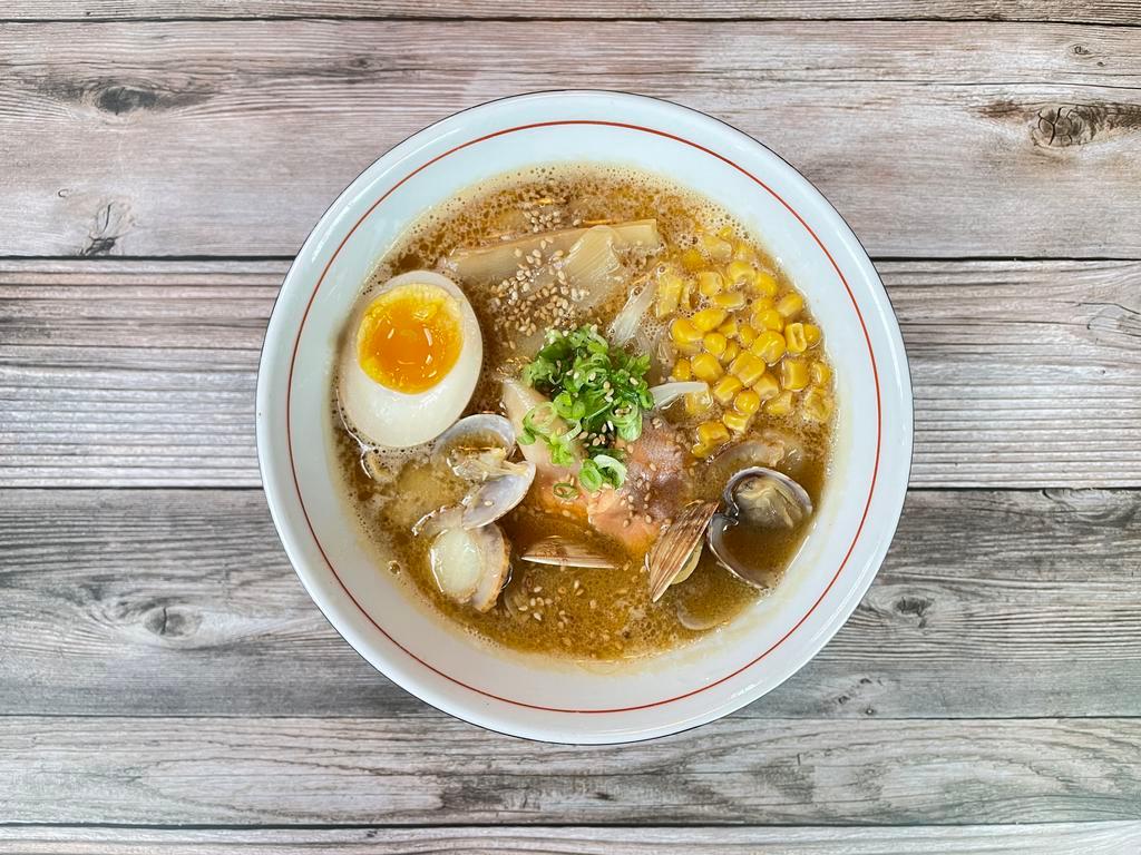 Fisherman Ramen · Local clam, octopus, sustainable coho salmon, scallops and miso broth, half egg, bean sprout, bamboo shoots, sweet corn,  scallions