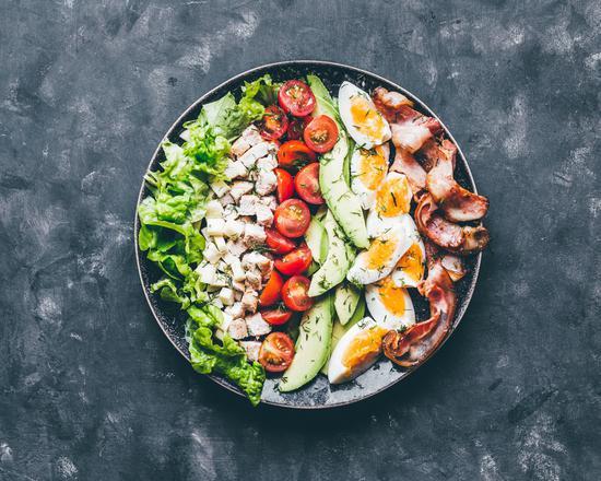 Cobb Salad · Fresh salad made with sliced lean chicken breast with shredded carrots, sliced mushrooms, tomatoes and avocado on a bed of mixed greens.