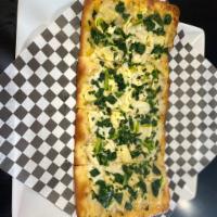 White Spinach and Artichoke Flatbread Pizza · Made with a base of our garlic white sauce topped with spinach, artichokes, and mozzarella c...