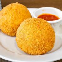 Sicilian Rice Balls · Served with sauce and fresh mozzarella cheese melted.