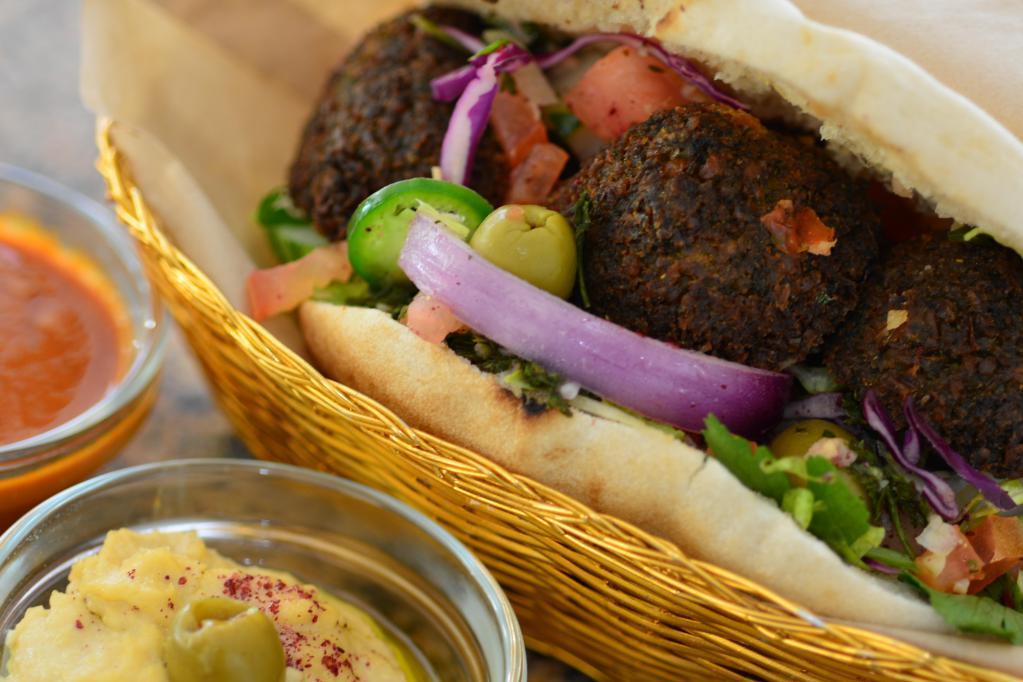 Full Falafel · Falafel balls in a full-size pocket pita with hummus, lettuce, tomato, and cucumber salad. Served with tahini and hot sauce.