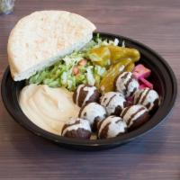 Falafel Platter · 8 falafel balls, hummus, lettuce, tomato and cucumber salad, full pocket pita on side. Serve...
