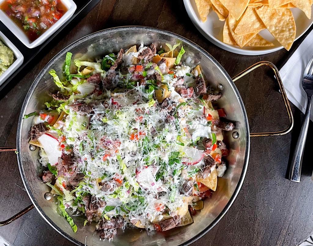 ★Nachos · Loaded with tender meat (Asada or Chicken), queso fresco, refired beans, Pico  de Gallo, jalapeno, lettuce, sour cream, and parmesan cheese on top.
