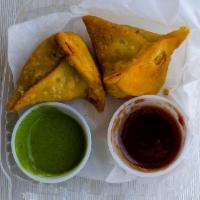 Samosa * · 2 pieces. Deep-fried triangle pastry stuffed with mildly spiced potatoes, and peas. Served w...