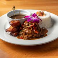 Traditional Ropa Vieja · Shredded flank steak with sofrito, plantains, served with rice & beans.