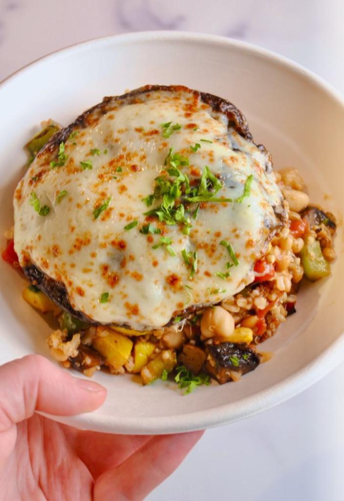 Grilled Veggie Bowl · The ultimate veggie Dish with roasted fresh zucchini, yellow squash, red & green peppers, spinach, portobello mushrooms with mozzarella, red pepper sauce, and mixed grains.