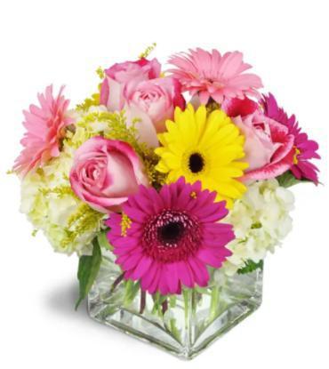 Strawberry Bliss · Deliciously fun! She’ll love this bright, brilliant pink arrangement, filled to the brim with cheerful gerbera daisies and charming pink roses. For a birthday it’s an ideal gift or a special gesture for any day. Hot pink and yellow gerbera daisies, pink roses, and creamy hydrangea are arranged in a modern clear glass vase. Product ID UFN 1099 approximately 11