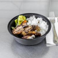 Jerk Chicken Bowl · Choice of rice & served steamed mixed veggies (cauliflower, brocolli, carrots). Smothered in...
