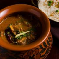 Handi Lamb Curry · Homestyle Punjabi lamb curry served in a ceramic handi.