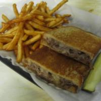 The Retriever Sandwich · Thinly sliced rib-eye steak smothered with cheddar cheese and sauteed onions on your choice ...