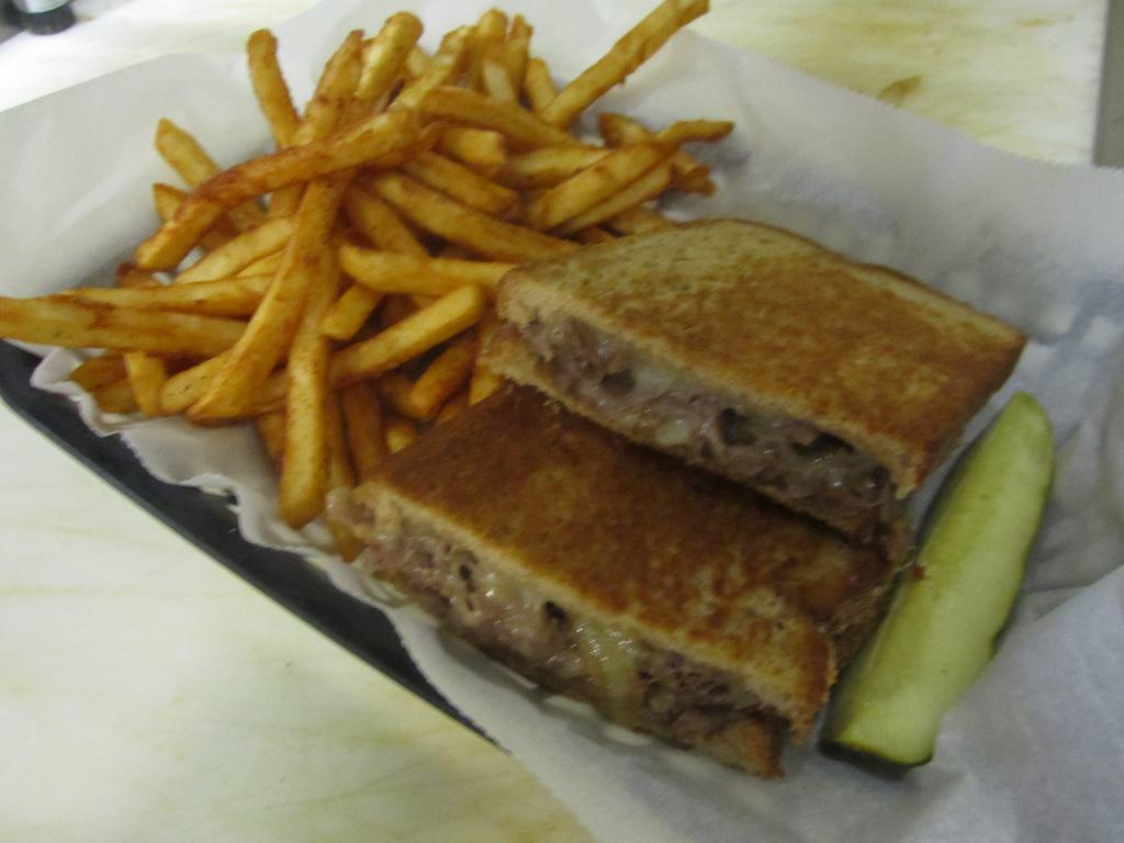 The Retriever Sandwich · Thinly sliced rib-eye steak smothered with cheddar cheese and sauteed onions on your choice of bread.