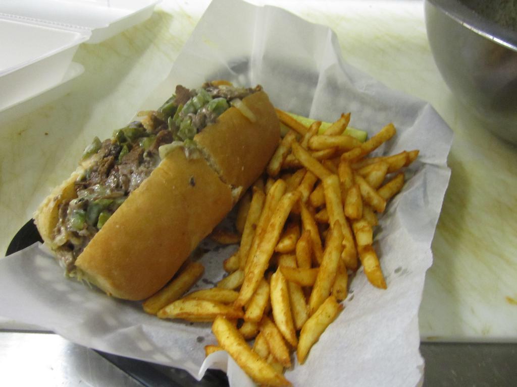 Philly Cheesesteak Sandwich · Served with peppers, onions, mushrooms and American cheese on a sub roll.