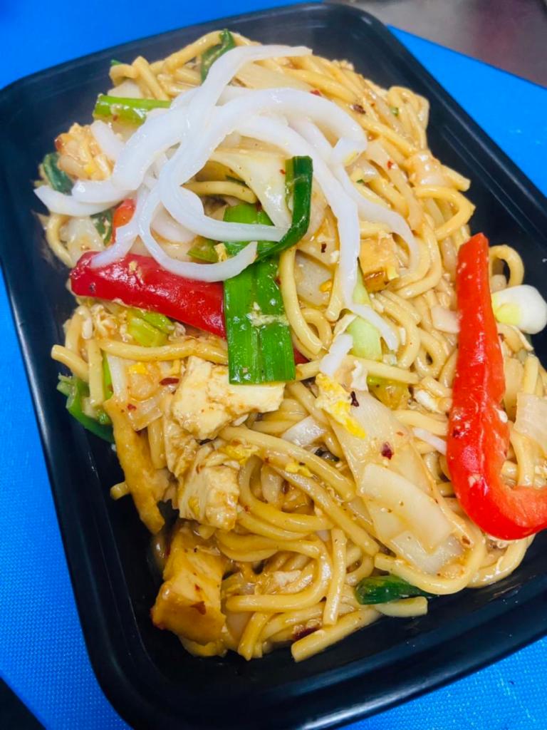 Yakisoba Coconut Noodle (FUSION) · Egg noodles stir fried with young coconut, egg, onions, bell peppers, basil, chili, and garlic coconut sauce top with bean sprout, and lime. 